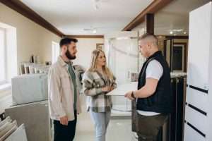 Couple choosing tiles in ceramic and furniture shop for