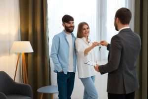 male-real-estate-agent-doing-business-showing-house-potential-buying-couple