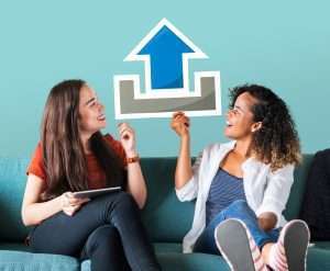 young-female-friends-holding-upload-icon
