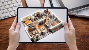Hands holding tablet computer with augmented reality image of a home's interior layout