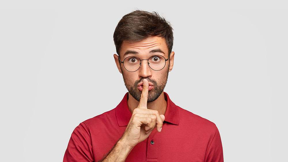 6 Best-Kept Secrets to Sell Your Home Faster Man tells a secret and holds his finger to his mouth